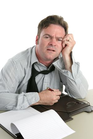 A tired looking office worker having trouble concentrating.の写真素材