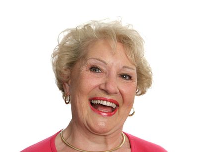 A beautiful senior woman laughing out loud.  Isolated on white.の写真素材