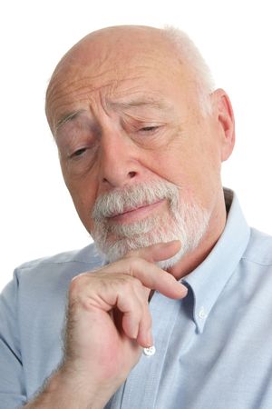 An intelligent senior man thinking over a problem.の写真素材