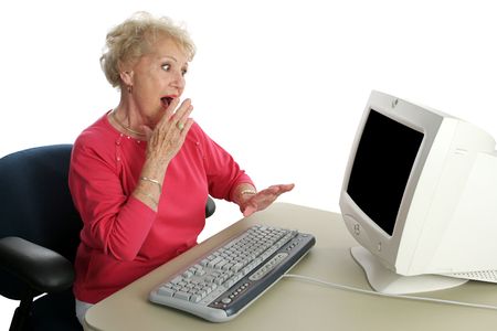 A senior woman viewing shocking internet content.  Screen intentionally blank, ready for text or...
