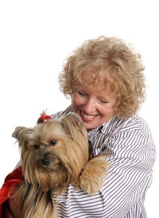 An affectionate pet owner giving a hug to her little yorkie dog.  Isolated.の写真素材
