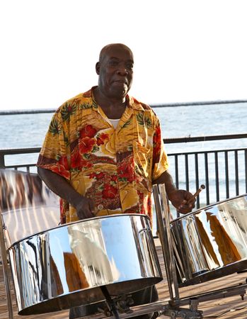 A caribbean musician playing steel drums.の写真素材