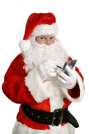 Santa Clause making his list on his personal computer.  Isolated over white.の写真素材