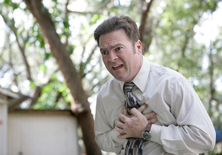 A forty year old businessman outdoors experiencing chest pain. の写真素材