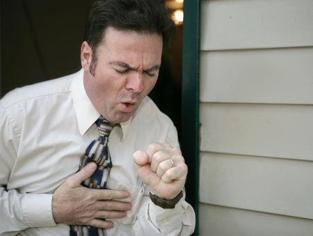 A man leaving work early because of a coughing fit.の写真素材