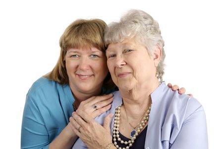 A warm loving portrait of an adult daughter and her elderly mother.  Isolated on white.  
