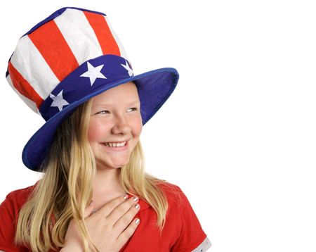 A beautiful young girl dressed patriotically and saying the Pledge of Allegiance. White background with room for text. の写真素材