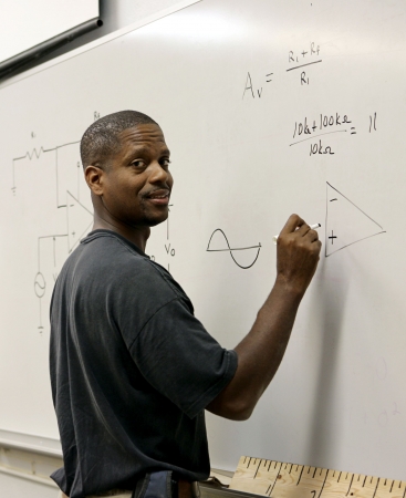 A handsome african-american student at the board doing trigonometry.  の写真素材