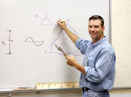 A handsome teacher drawing a mathematical diagram on the white board.の写真素材