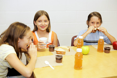 A group of school children having lunch in the school cafeteria.の写真素材