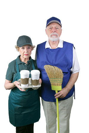 A senior couple unable to retire is working in the fast food and retail industries.  Isolated on white.    の写真素材