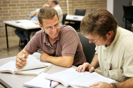 Adult education students studying together in class.