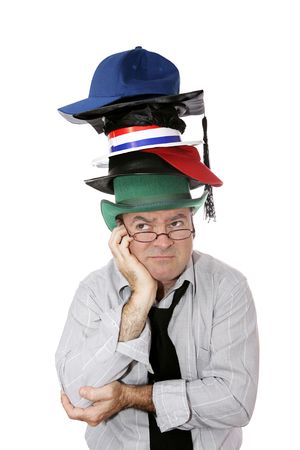 A discouraged businessman or academic wearing too many hats.  Isolated on white.の写真素材