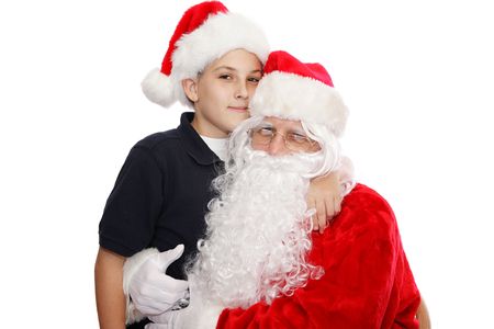 A cute school boy posing for a photo with Santa.  Isolated on white.  の写真素材