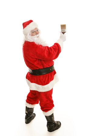 Full body view of Santa Claus using a 3 inch paintbrush on a white background.  の写真素材