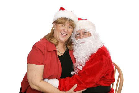 Santa Claus hugging a woman who is sitting on his lap. Isolated on white.  の写真素材