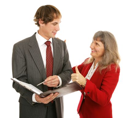 Female boss congratulating her young male employee, giving him a thumbs-up.  Isolated on white.  の写真素材