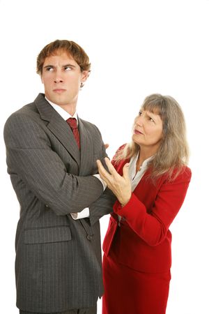 Mature businesswoman trying to explain to a stubborn young male employee.  Isolated on white.の写真素材