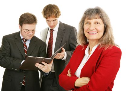 Mature successful woman business leader with her team.  Isolated on white.  の写真素材