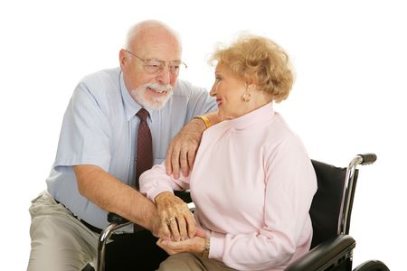 Loving senior couple coping with the wife's disability.  Isolated on white.  の写真素材