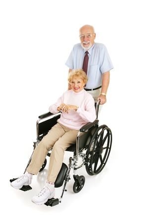 Senior man pushing his wife in wheelchair.  Full body isolated on white.  の写真素材