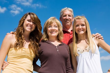 Beautiful family of grandparents and granddaughters against a blue sky.  の写真素材