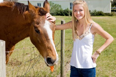 Beautiful teen girl on the farm with her horse.  の写真素材