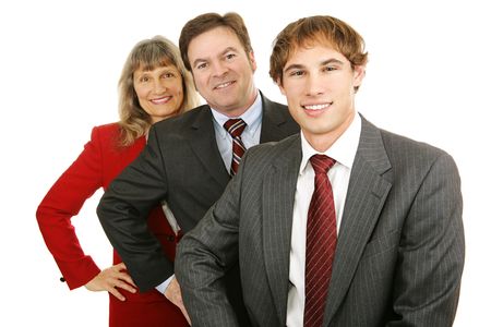 Young business leader with middle aged man and woman.  Isolated on white.  の写真素材