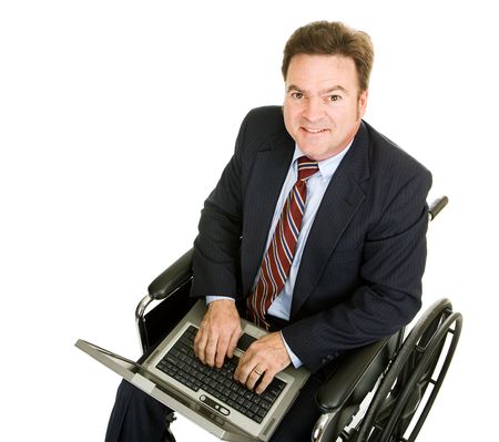 Disabled businessman typing on his laptop computer.  Isolated on white.  の写真素材