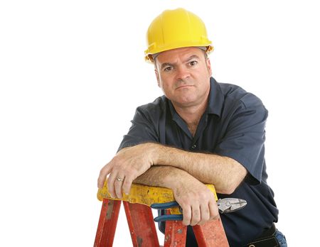 Unhappy, dissatisfied construction worker on a ladder.  Isolated on white.  の写真素材