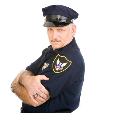 Handsome policeman leaning back on invisible white space, with a sexy expression.  Isolated design element.の写真素材