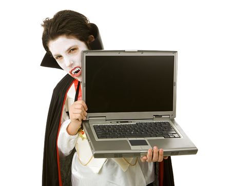 Cute Halloween vampire holding a laptop computer over white background.  LCD screen is blank and ready for your text.  の写真素材