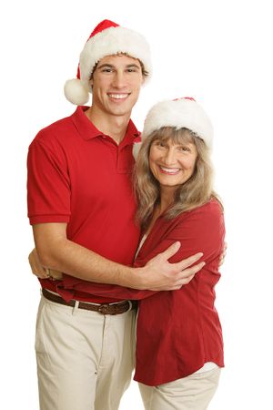 Portrait of proud single mother and handsome young adult son at Christmas time.  Isolated on white.  の写真素材