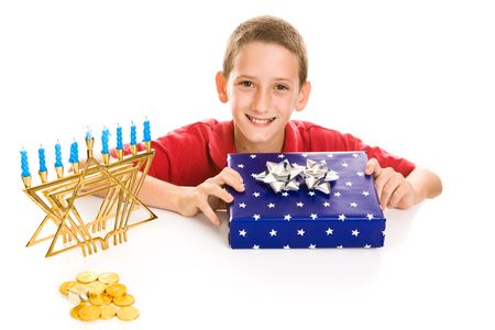 Happy little boy excited about opening his hanukkah gift.  Isolated on white.の写真素材