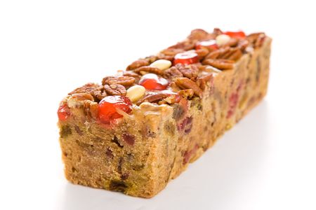 Moist, delicious Christmas fruitcake isolated on white background.  の写真素材