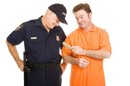 Inmate in orange jump suit offering a bribe to a police officer.  Isolated on white.  