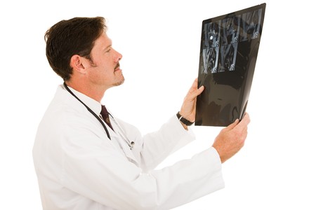 Handsome doctor examining the results of and MRI scan.   