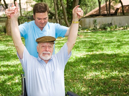 Senior man with arthritis is not enjoying his physical therapy session.  