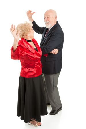 Senior couple having a great time dancing together.  Full body isolated on white.  の写真素材