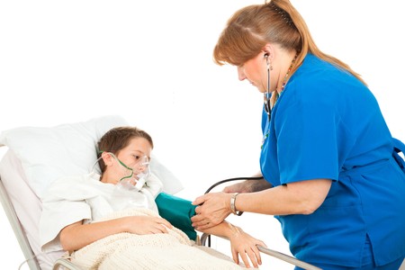 Little boy in hospital watching a nurse take his blood pressure.  の写真素材
