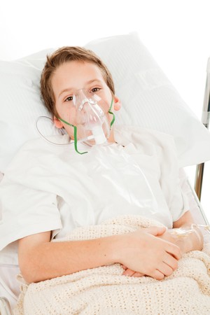 Sick little boy in the hospital breathing with an oxygen mask.  の写真素材