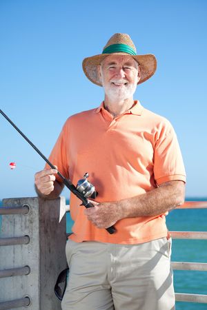 Happy senior man enjoys a day of fishing.  の写真素材