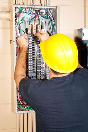 Electrician replacing a bad circuit breaker in a large industrial panel.