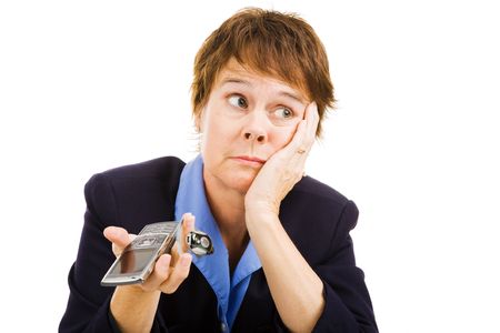 Businesswoman worried because no calls are coming in.  Business at a standstill.  Isolated on white.の写真素材