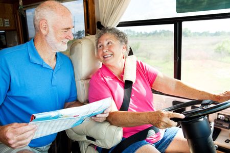 Senior couple riding in their motor home consult a map.  の写真素材