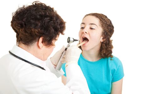 Teen girl opening her mouth so the doctor can check her throat.  Isolated on white.の写真素材