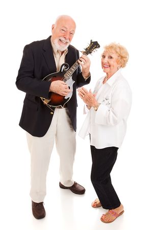 Senior man plays mandolin while his wife sings along.  Full body isolated.の写真素材