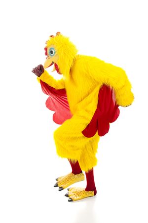 Man in a chicken suit running away.  Isolated on white.  の写真素材