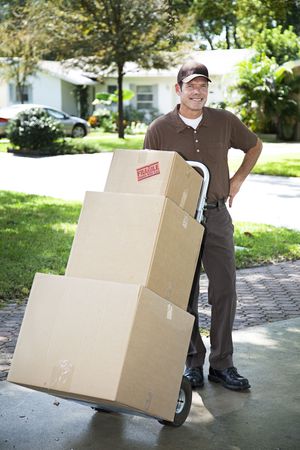 Mover or delivery man arrives with a stack of boxes for you.  の写真素材