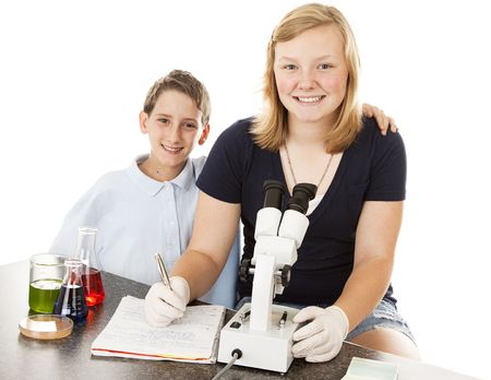 Children at school, doing science experiments and examining results under microscope.  White background.の写真素材